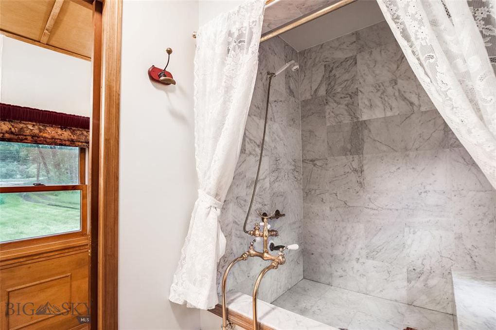 Shower/tub combo with carrera marble in restored Victorian train car