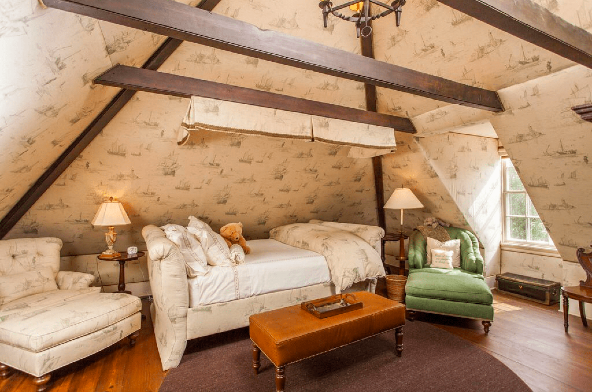 Attic with exposed beams and wallpaper in historic home