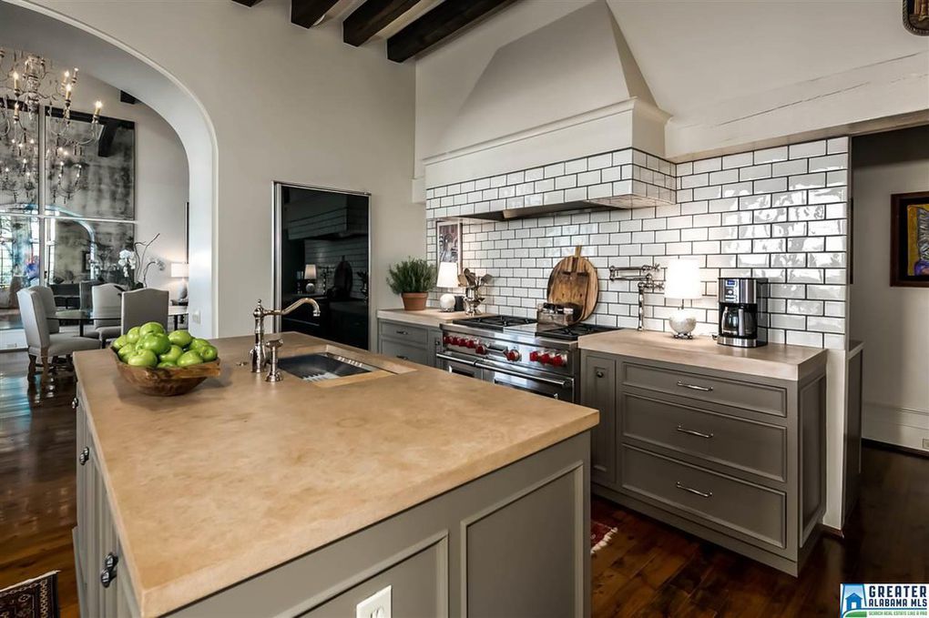 Kitchen with exposed beams and subway tile
