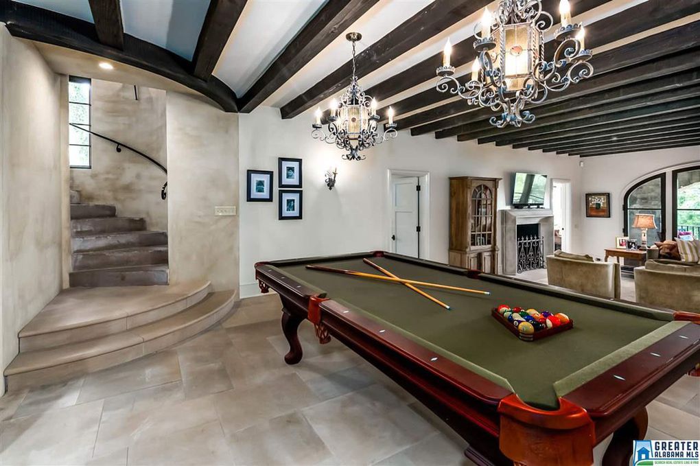 Pool table and stone staircase to entertaining area in Birmingham home