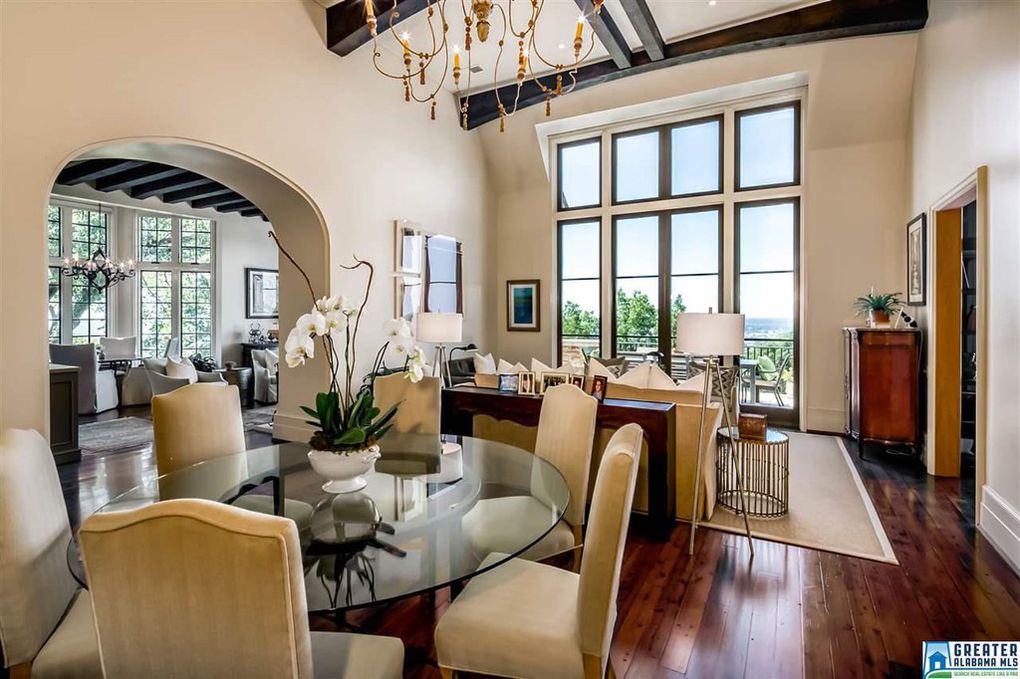 Arched ceiling beams, soaring windows and ceilings in living space